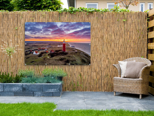 Foto auf Gartenposter Leuchtturm bei Sonnenuntergang
